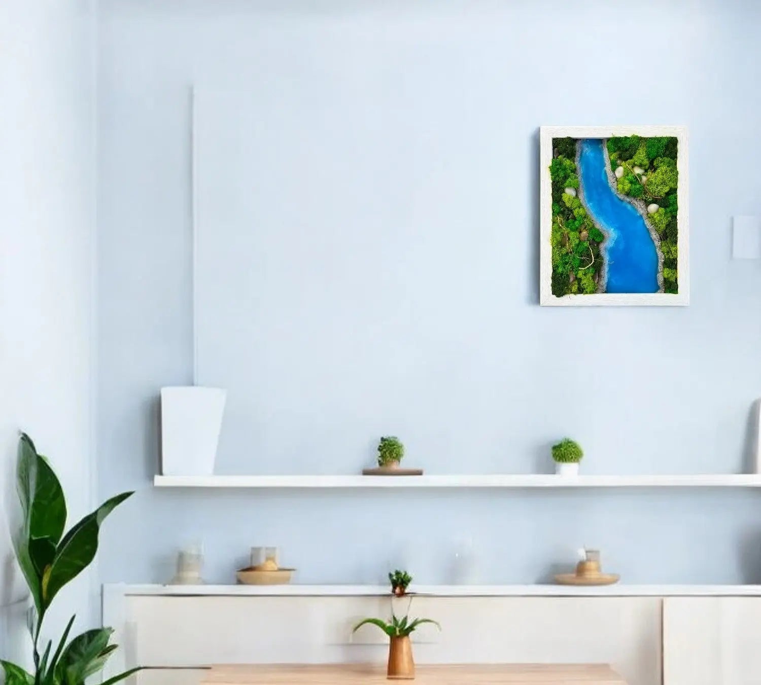 one wall decor contains variety of green color preserved moss with sky blue color epoxy resin and rock stones in rectangular shape hanging on the wall with plants and decorative items on shelfs and side tables 