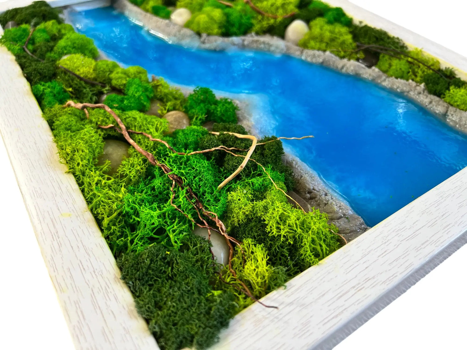 a close up image of wall decor contains variety of green color preserved moss with sky blue color epoxy resin and rock stones in rectangular shape