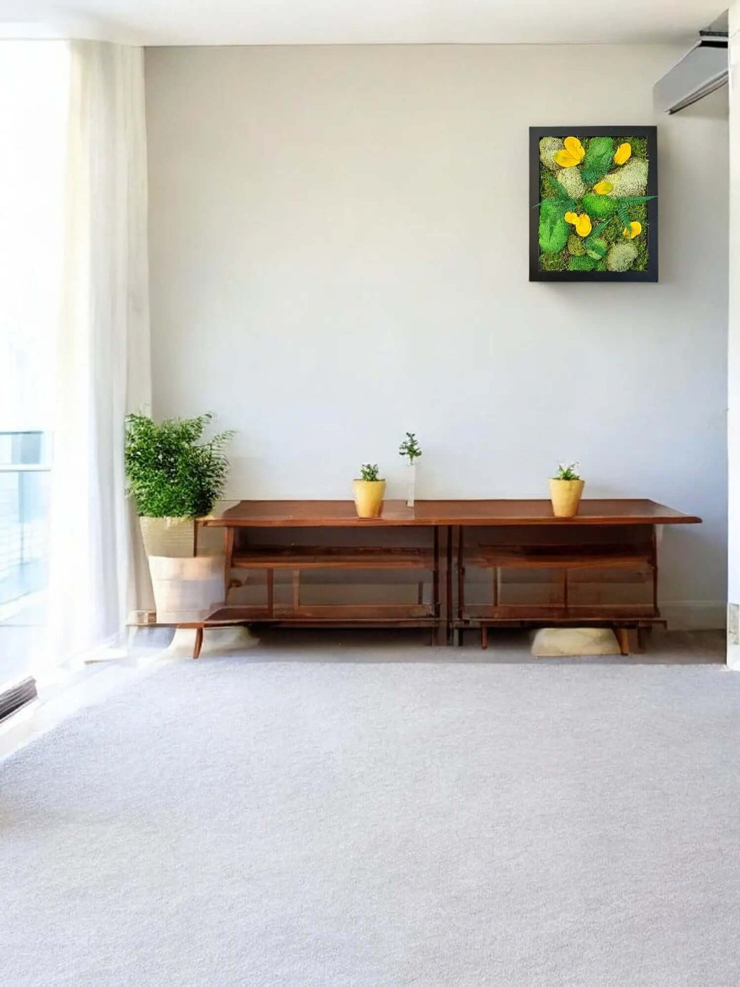 Unique 16x13 inch preserved moss wall art with artificial flowers and natural wood accents.
Preserved moss wall art hanging above a console table in a modern living room.