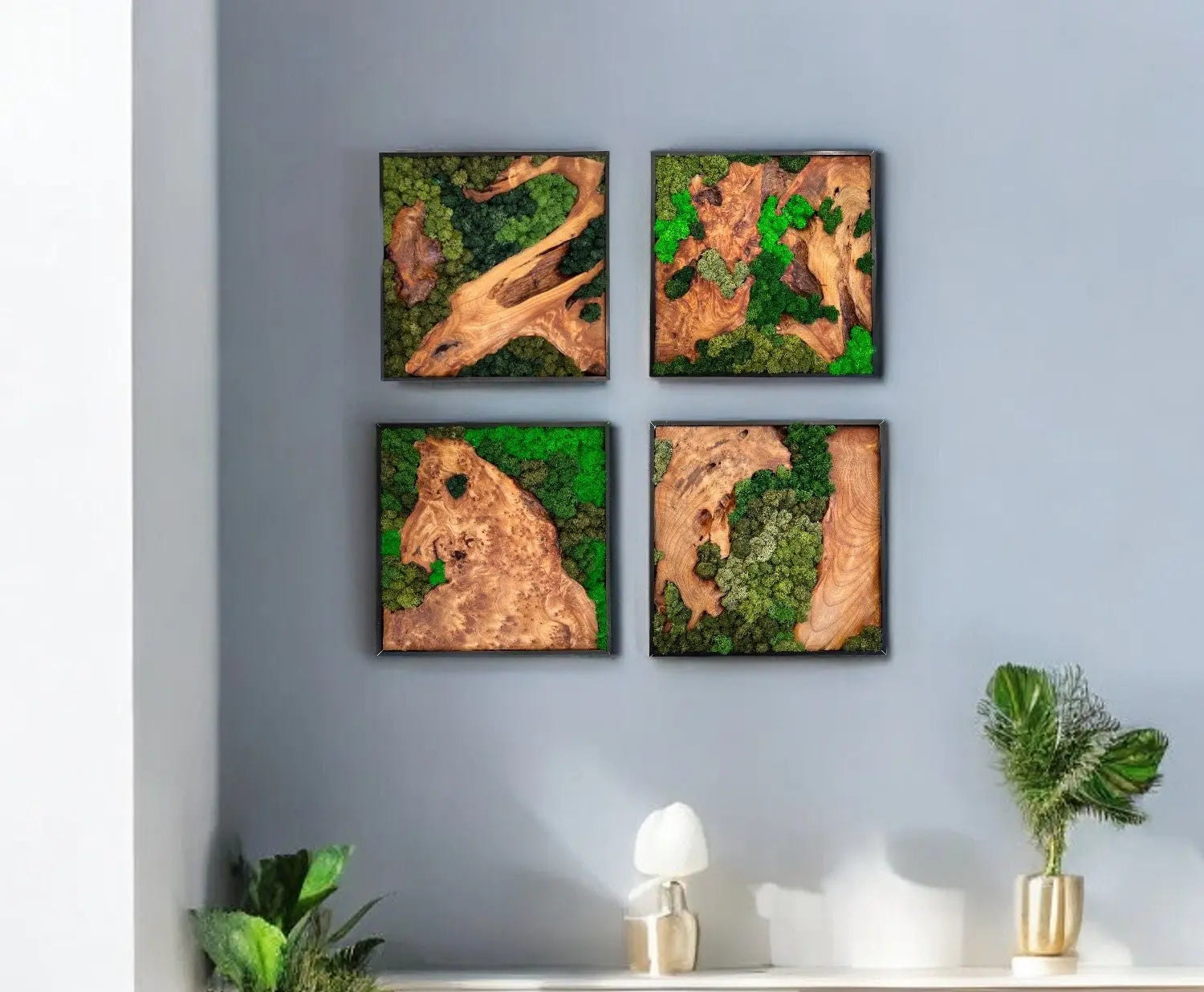 four squared shape wall decor of cedar wood with variety of green colored preserved moss wall decor hanging on the wall with green plants sitting on a table