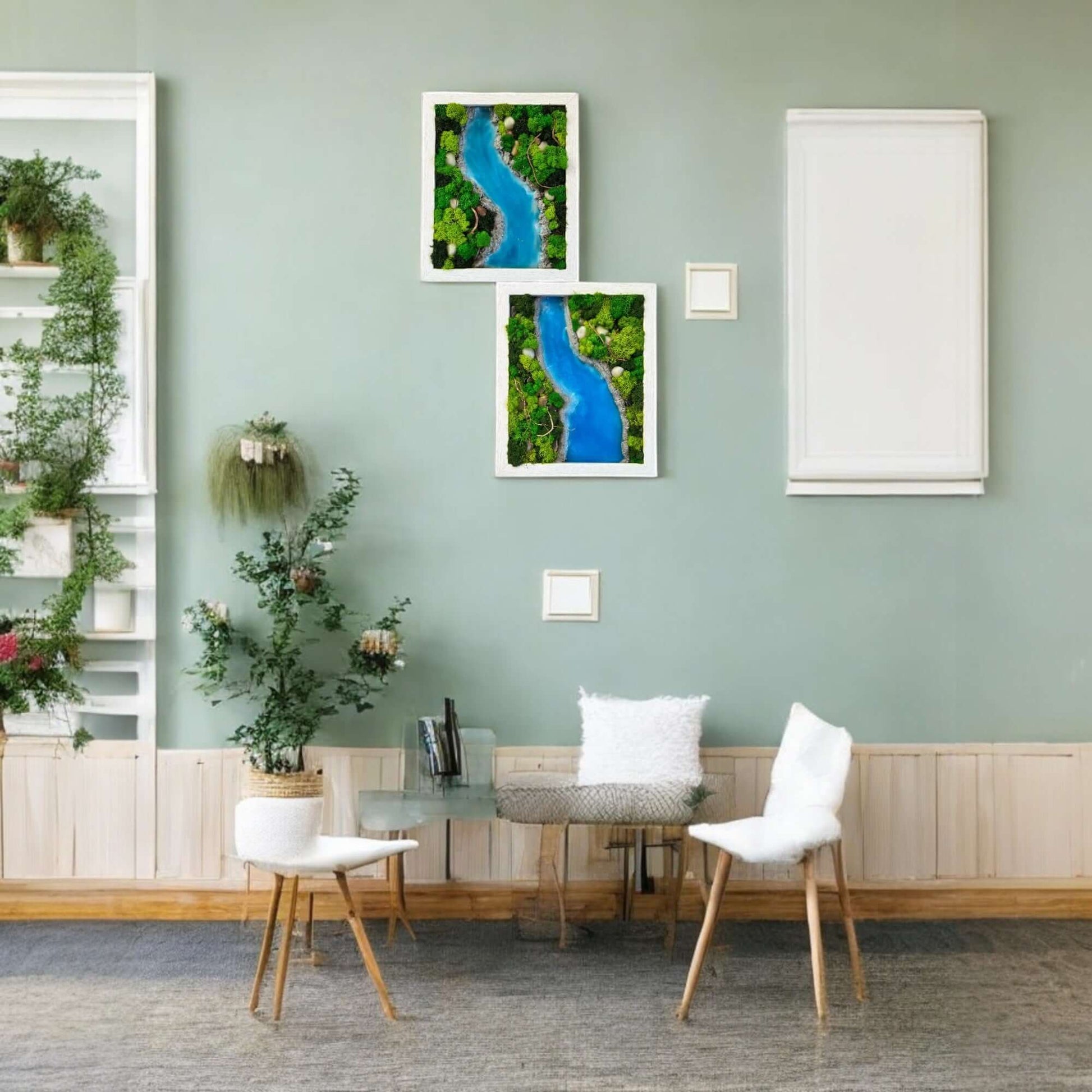 Epoxy and moss wall art with a sky-blue epoxy river design hanging above a console table with plants and decor. A cozy couch sits in the foreground, creating a tranquil and inviting living room atmosphere