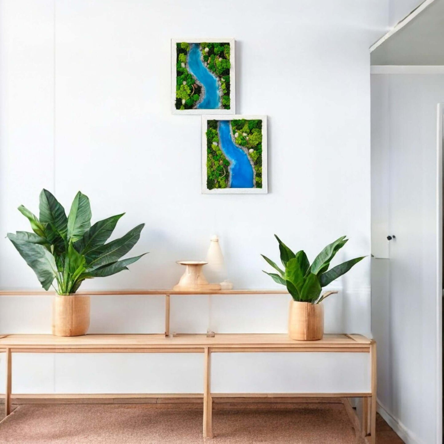 Unique epoxy and moss wall art featuring a sky-blue river transforms this living room.  Hangs above a console table with decor, complementing the cozy couch and creating a natural focal point